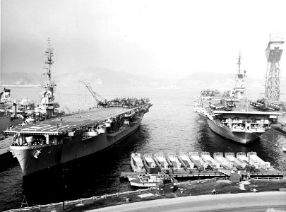 USS Sicily (CVE-118) and USS Yorktown (CVA-10) at Yokosuka Naval Base, Japan, circa in February 1954 (NH 97318)