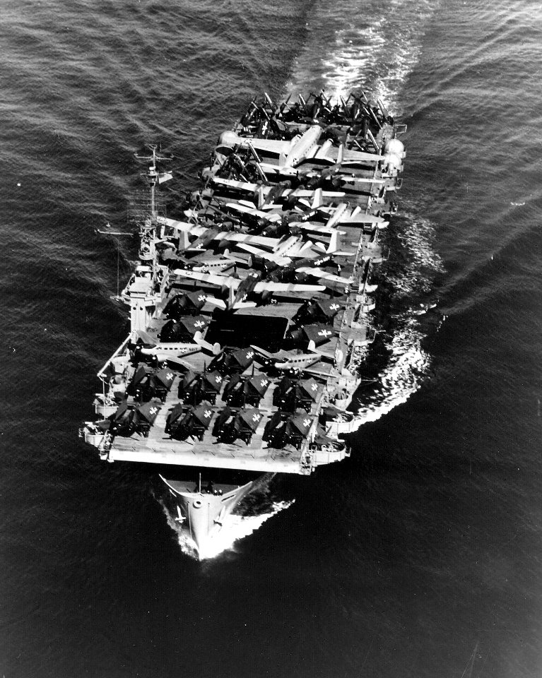 USS Sitkoh Bay (CVE-86) underway transporting aircraft 1950s
