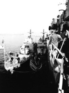 USS Surprise (PG-97) and USS Defiance (PG-95) tied up to USS Austin (LPD-4) c1971