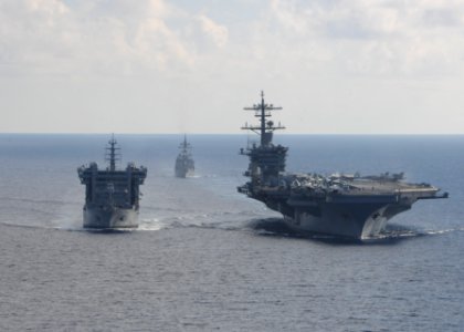 USS Theodore Roosevelt pulls alongside INS Shakti during a replenishment-at-sea exercise as JS Fuyuzuki approaches