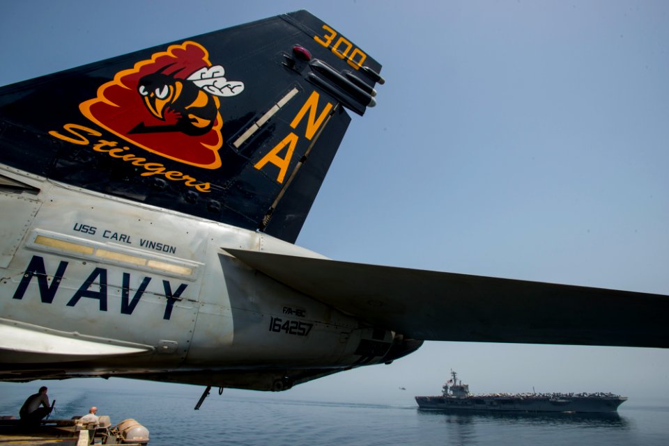 USS Theodore Roosevelt, background, relieves USS Carl Vinson in the Gulf of Oman. (17187167596)