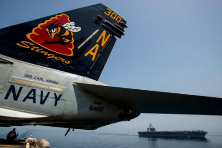 USS Theodore Roosevelt, background, relieves USS Carl Vinson in the Gulf of Oman. (17187167596)