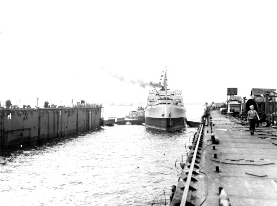 USS Trinity (AO-13) enters the floating drydock ABSD-2 on 11 April 1945 at Seeadler Harbor