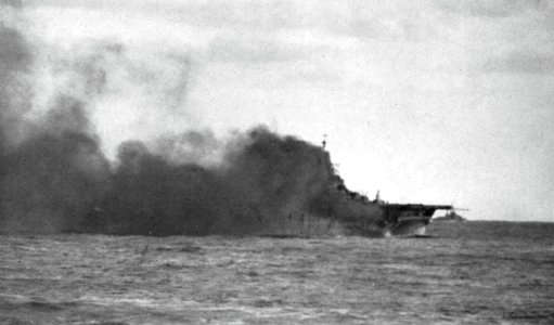 USS Wasp (CV-18) burnes after being hit by a Japanese 250kg bomb off Japan on 19 March 1945