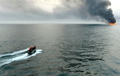 USS William P. Lawrence assists a buring vessel. (8559251087)