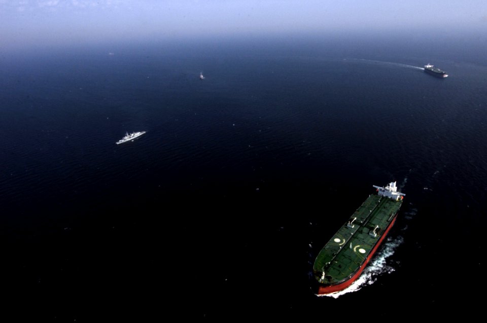 USS Winston S. Churchill escorts a commercial vessel. (8269159365)