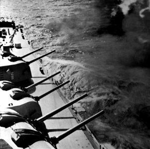 USS Worcester (CL-144) fires its forward 155mm guns, circa in 1957