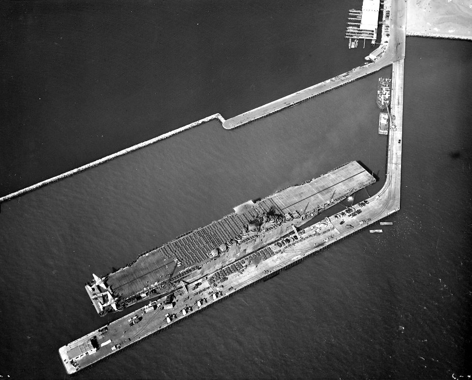 USS Yorktown (CV-10) loading aircraft, vehicles and supplies at Naval Air Station Alameda, California (USA), on 14 September 1943 (NNAM.1996.488.243.041)