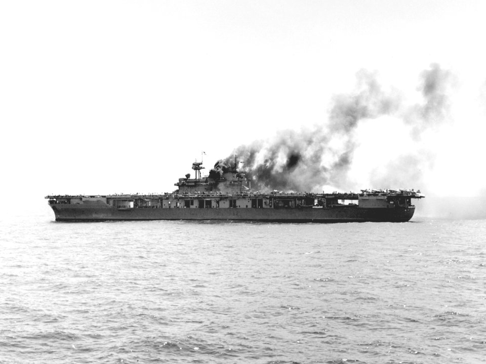 USS Yorktown (CV-5) burning after the first attack by Japanese dive bombers during the Battle of Midway on 4 June 1942