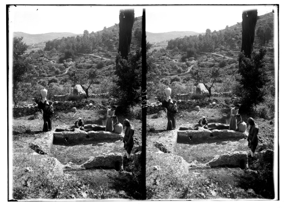 Various subjects of archaeological interest. A Canaanitish winepress at Ain Karem. Natives with middle bronze jars. Matt. 21-33. 'hedged it round about and digged a winepress'. LOC matpc.03013
