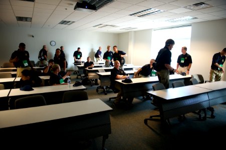 Various law enforcement explorers standing around a classroom