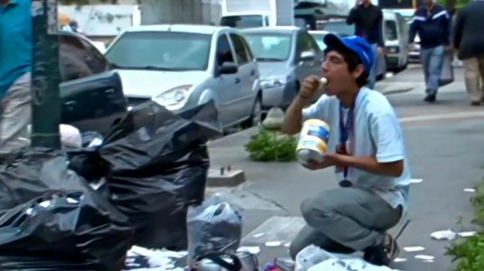 Venezuelan eating from garbage photo