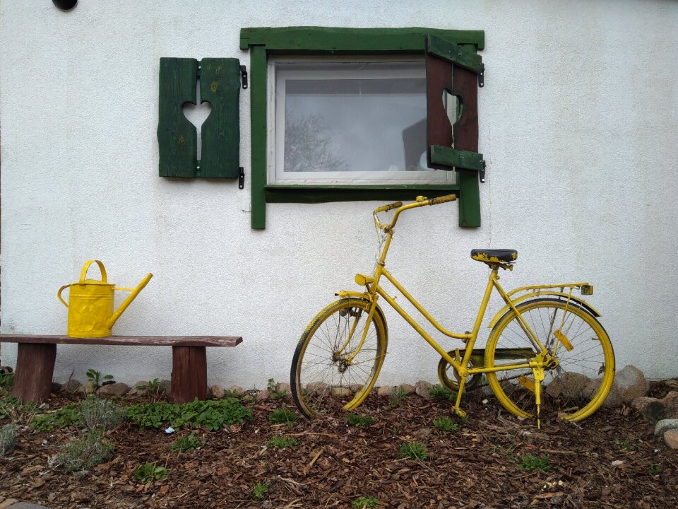Watering can yellow old house