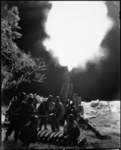 Veteran Artillery men of the C Battery., 90th Field Artillery., lay down a murderous barrage on troublesome... - NARA - 531284
