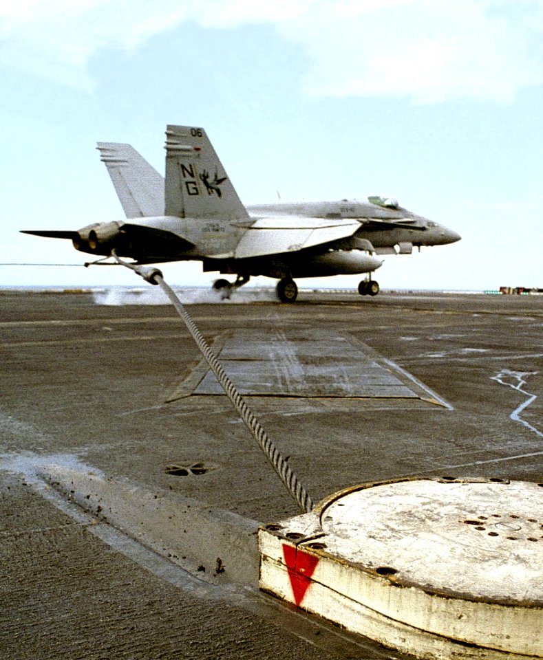 VFA-147 FA-18C Hornet catching arresting wire on USS Nimitz (CVN-68) 971106-N-6939M-269