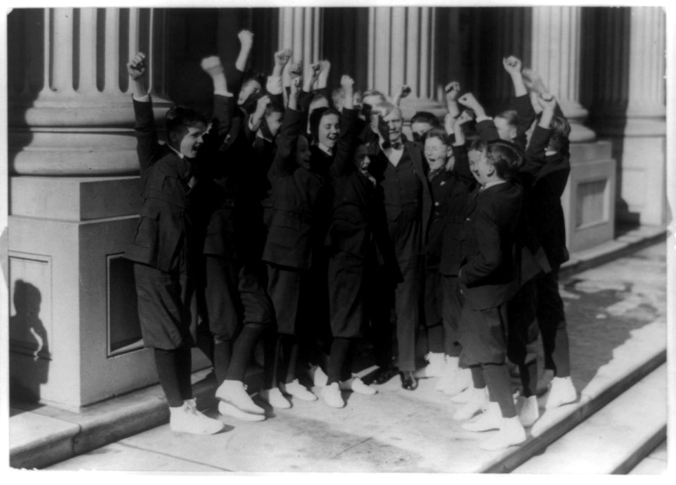 Vice President Thomas R. Marshall receiving a hearty cheer from Senate pages after he invited them to a Christmas dinner, standing on U.S. Capitol steps LCCN91786768