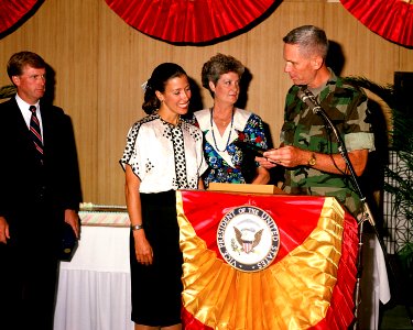 Vice President Dan Quayle looks as his wife, Marilyn Quayle accepts a gift from Lieutenant General Norman H. Smith