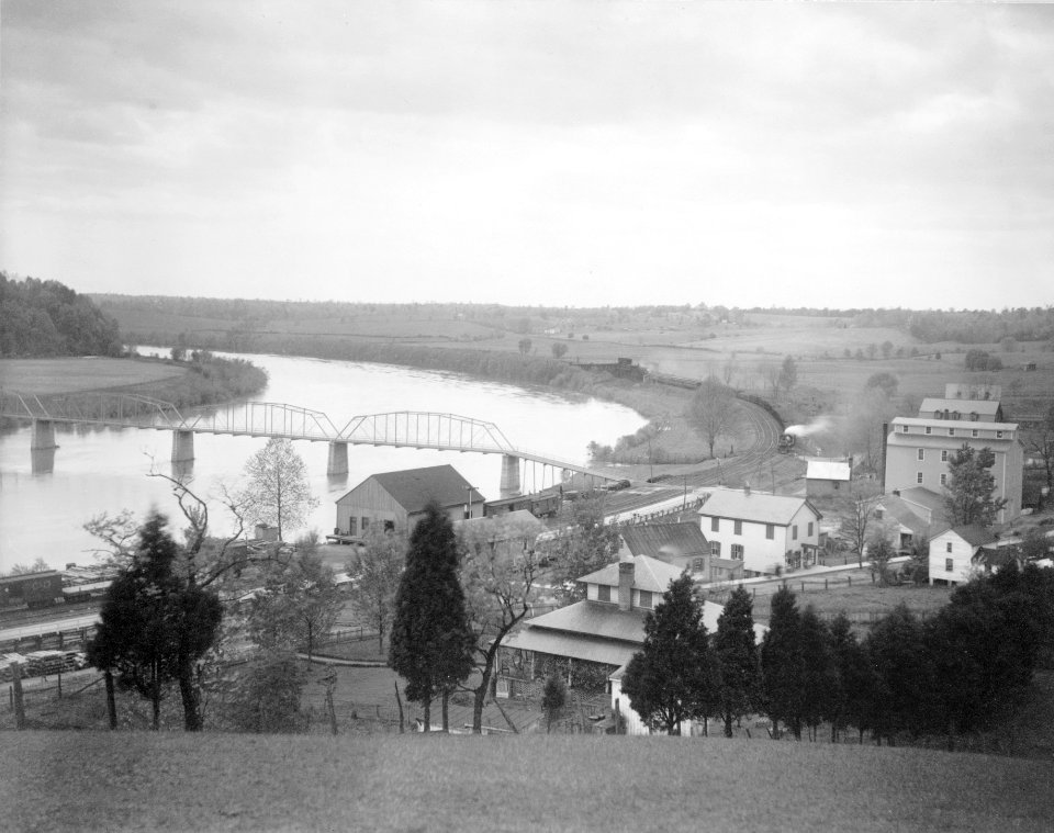 View from hillside of Old Scott's Ferry, Scottsville, Virginia, showing train approaching railroad bridge LCCN95501329