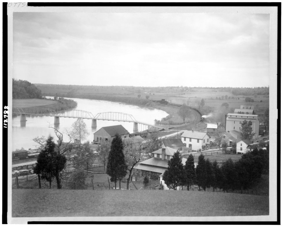 View from hillside of Old Scott's Ferry, Scottsville, Virginia, showing train approaching railroad bridge LCCN95501329