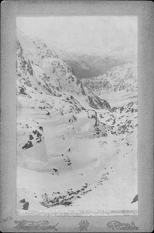 View from the summit of Chilkoot Pass looking down on Klondikers' encampment at the base, Alaska, 1897 (AL+CA 1699)
