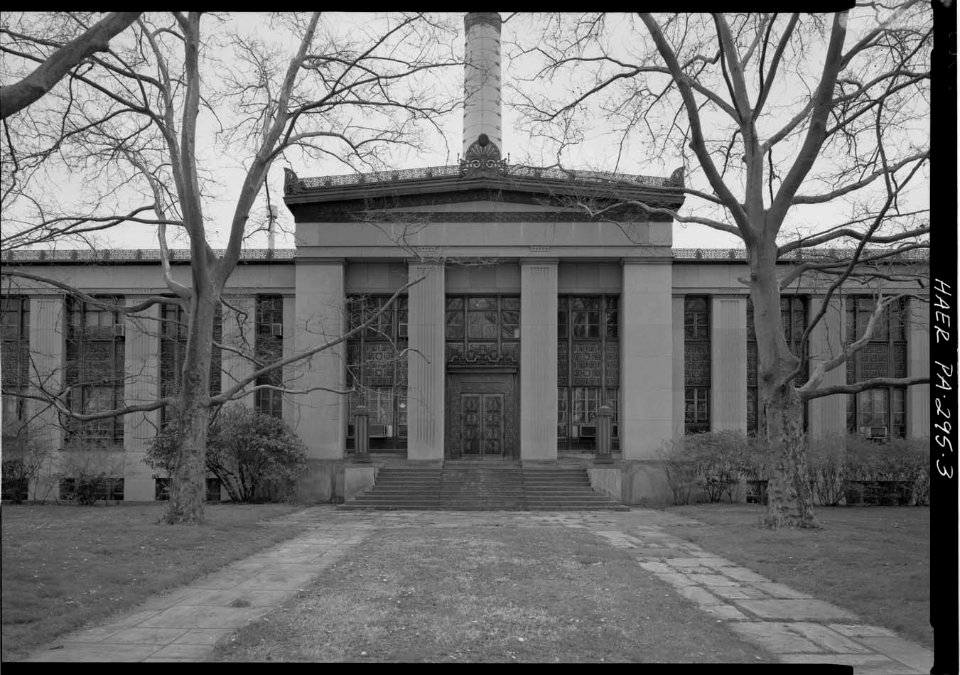 VIEW OF BUILDING ENTRANCE, SHOWING ALUMINUM DOORS, PANELS, AND STONE PILASTERS