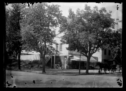View of corner general store on 20th Street, N.W., West side, looking North from E Street LCCN2016646800