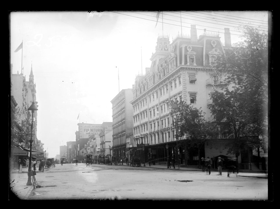 View of F Street, N.W., mostly South side, looking East from 14th Street showing Ebbitt House on the corner and other businesses nearby LCCN2016646802