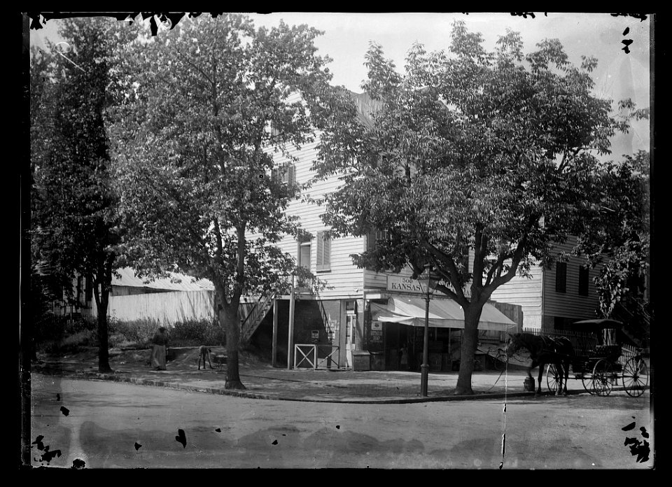 View of corner general store on 20th Street, N.W., West side, looking North from E Street LCCN2016646800