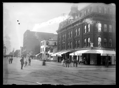 View of G Street, N.W., North side, looking West from 5th Street showing pedestrians in the street and a drugstore on the corner LCCN2016646870 photo