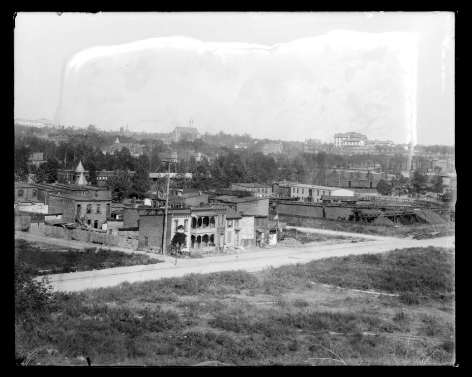 View of H Street, S.W., between Half & 1st Streets, in 1901 showing old homes near railroad station LCCN2016647111