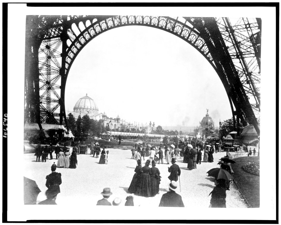View of the Palace of Fine Arts on left, and the Central Dome on right, seen through the base of the Eiffel Tower, with people walking under the Tower, Paris Exposition, 1889 LCCN92519769