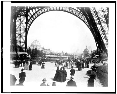 View of the Palace of Fine Arts on left, and the Central Dome on right, seen through the base of the Eiffel Tower, with people walking under the Tower, Paris Exposition, 1889 LCCN92519769