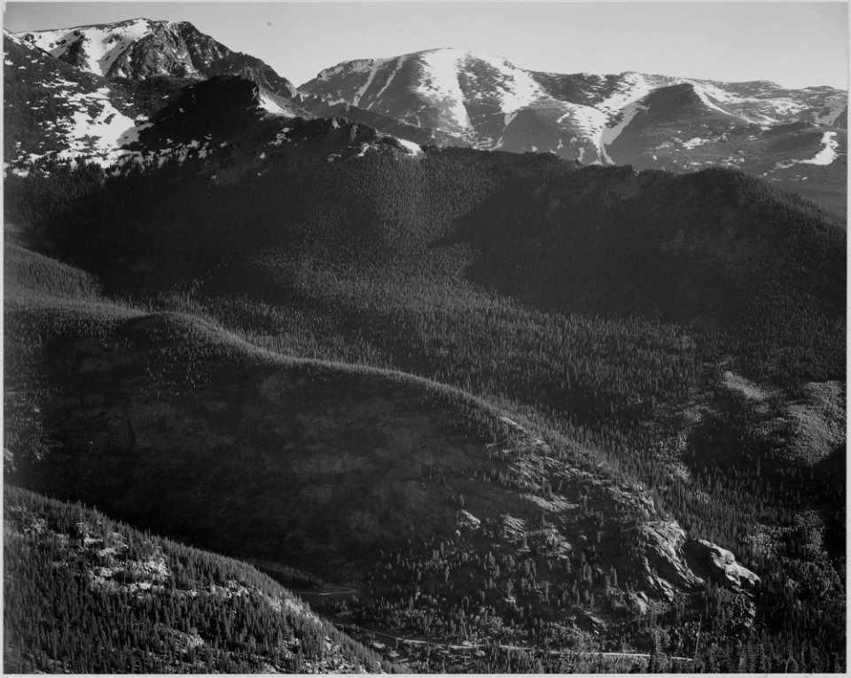 View of wooded hills with mountains in background, In Rocky Mountain National Park, Colorado., 1933 - 1942 - NARA - 519961
