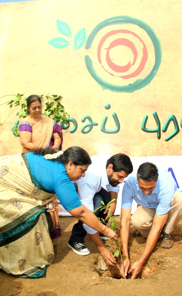 Vikram and Information Officer Anand Krishna plant a sapling at the YMCA grounds