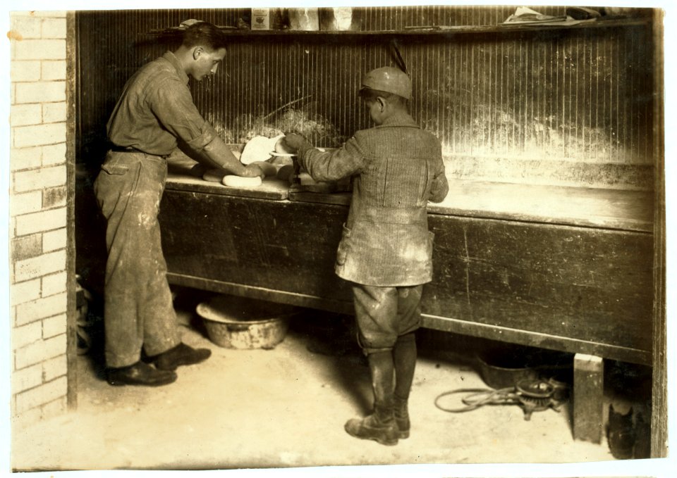 Vincenzo Messina, 15 years old and brother Angelo, 11 years old, baking bread for father, 174 Salem Street. Vincenzo is working nights now, from 5 p.m. to 5 a.m. Usually works on day shift. LOC nclc.05177