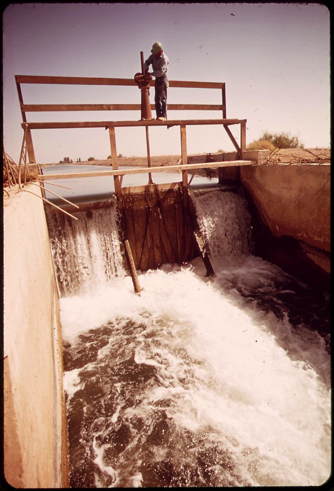 Vincent-humeumptewa-a-hopi-indian-and-an-employee-of-the-irrigation-district-opens-the-canal-gates-these-waters-are-no-longer-potable-because-they-contain-residue-from-the-weed-sprays-used-on-the-fields-may-1972 7152583811 o