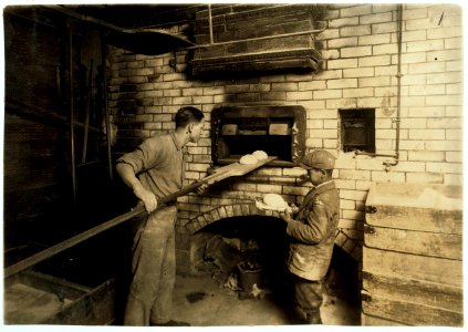 Vincenzo Messina, 15 years old and brother Angelo, 11 years old, baking bread for father, 174 Salem Street. Vincenzo is working nights now, from 5 P.M. to 5 P.M. Usually works on day shift. LOC cph.3b00363