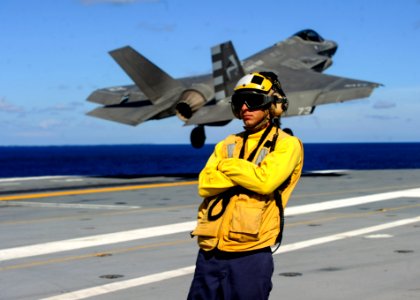 VX-23 F-35C Lighting II taking off during touch-and-go landing on USS George Washington (CVN-73) watched by plane handler (160820-N-VH385-826)