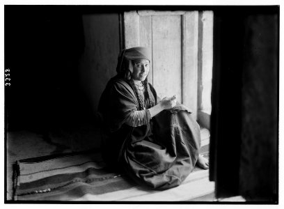Wady Shaib Es-Salt, Amman, etc. Christian Bedouin girl of Es-Salt, sitting in doorway, sewing. LOC matpc.02737