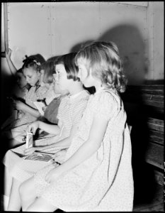 Wanda Lee Sergent, in striped dress, in Sunday School at the Pentecostal Church of God. Lucy and some of the children... - NARA - 541348