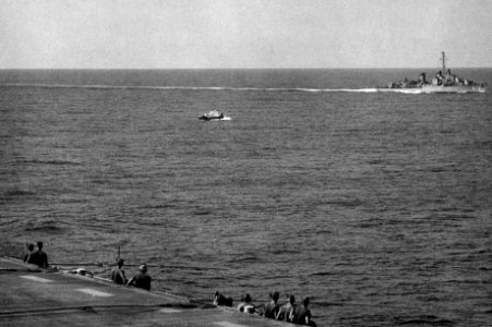 SNJ-5C Texan crashing off USS Monterey (CVL-26) and USS Forrest Royal (DD-872), in 1953 (NNAM.1996.488.014.010)