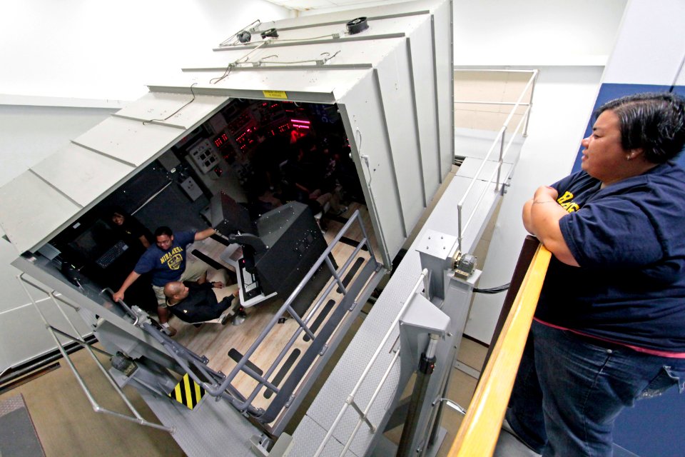 Students from Mira Mesa High School Air Force Junior Reserve Officer Training Corps (JROTC) experience a simulated emergency blow in the Ship's Control Station trainer