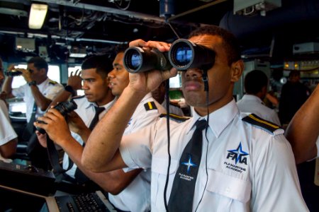 Students from the Fiji Maritime Academy on the bridge of the USS Shoup