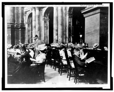 Students in the Reading Room of the Library of Congress with the Librarian of Congress, Herbert Putnam, watching LCCN98502945
