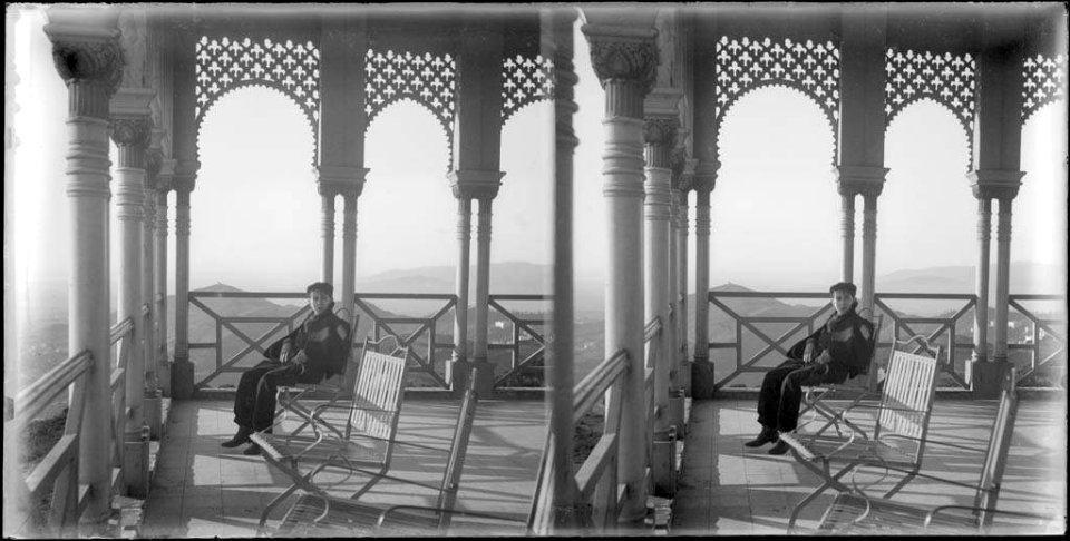 Un nen assegut a una galeria del pavelló de la Reina del Tibidabo