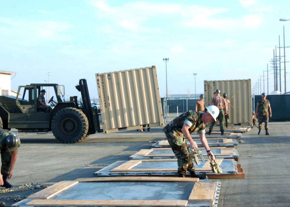 US Navy 060831-N-3560G-035 Members of Naval Mobile Construction Battalion Four (NMCB-4) prepare shipping pallets for Tricon containers