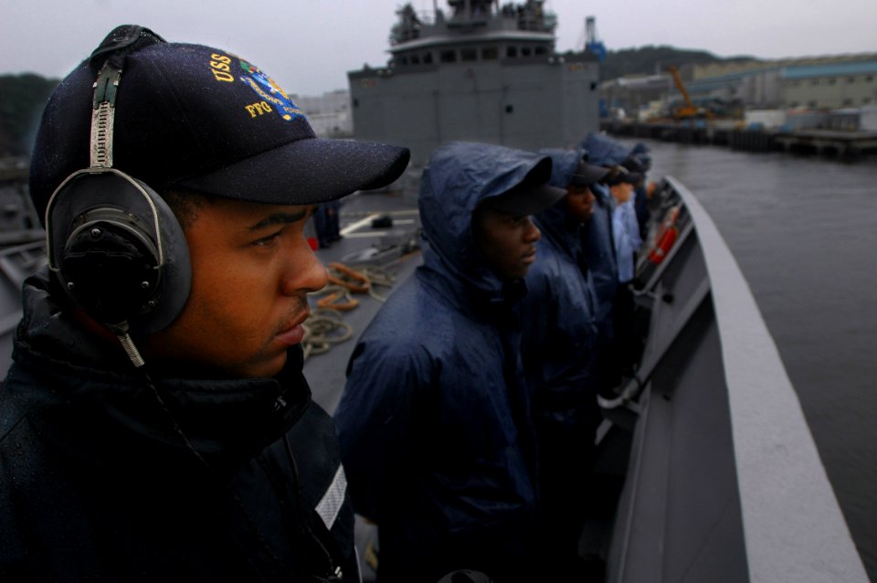 US Navy 060901-N-1332Y-035 Ship's Serviceman 3rd Class Anthony Benson mans the rails with fellow Sailors aboard the guided missile frigate USS Gary (FFG 51) as they depart Commander, Fleet Activities Yokosuka