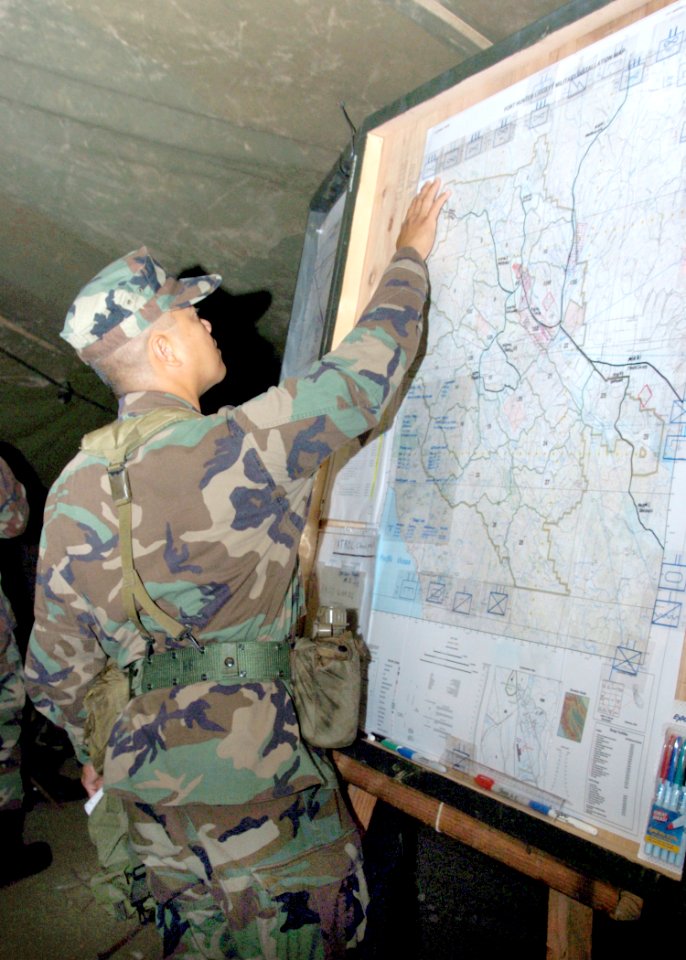 US Navy 060831-N-3560G-010 Lt.jg Neil Ebuen of Naval Mobile Construction Battalion Four (NMCB-4) reviews the Operations and Intel Tracker