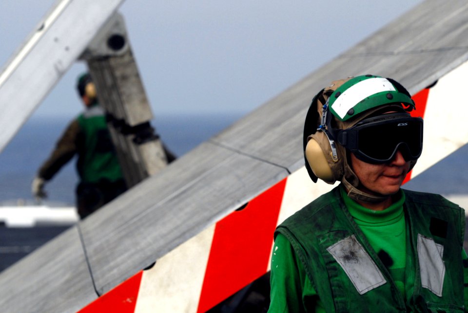 US Navy 060829-N-8158F-068 Aviation Boatswain's Mate Equipment 3rd Class Joanna Manis of Del Rio, Texas, stands as a safety observer during a Jet Blast Deflector (JBD) emergency lowering drill on the flight deck aboard th