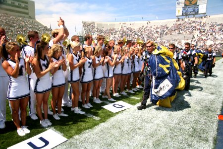 US Navy 060909-N-3271W-002 The Brigham Young University Cheer Squad greet the U.S. Navy Parachute Demonstration Team Leap Frogs after they parachuted into the stadium prior to the game photo